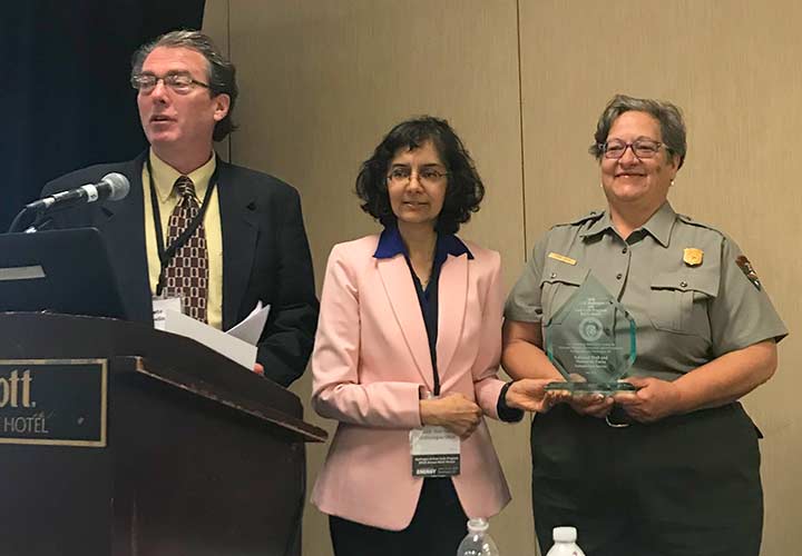 Pete Devlin and Sunita Satyapal present an award plaque to Robin Nixon.