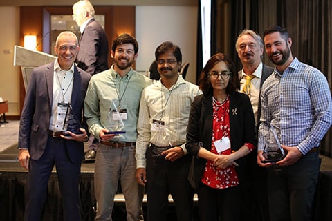 Chris Capuano, Jamie Kee, Krishna Reddi, and Shaun Onorato stand with their award trophies alongside Sunita Satyapal and Eric Miller.