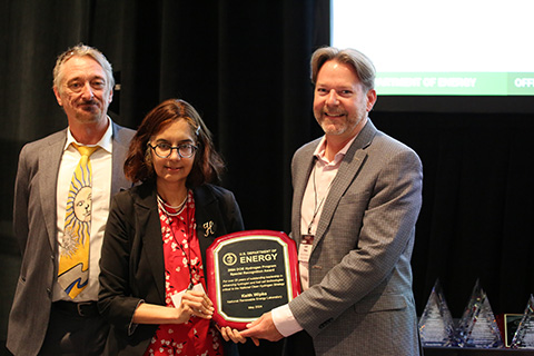 Keith Wipke stands with his award plaque alongside Sunita Satyapal and Eric Miller.